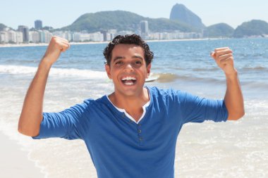 Cheering latin guy at Copacabana beach at Rio de Janeiro