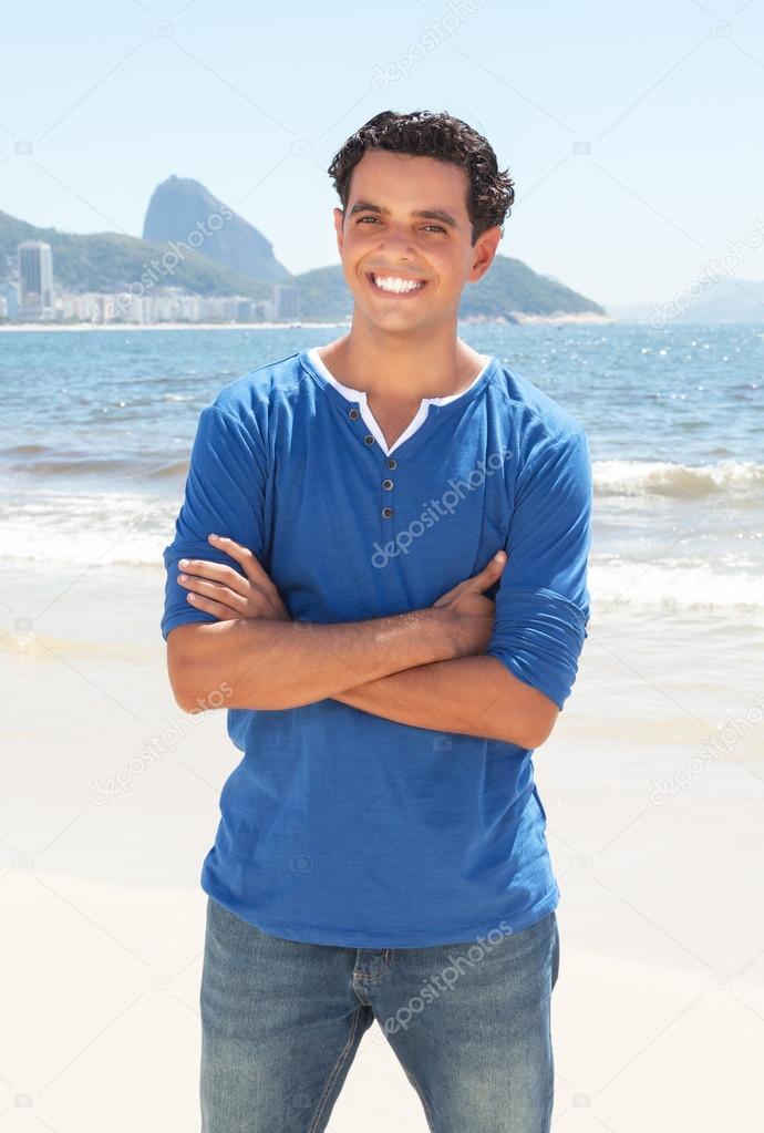 Latin guy with crossed arms at Copacabana beach at Rio de Janeir