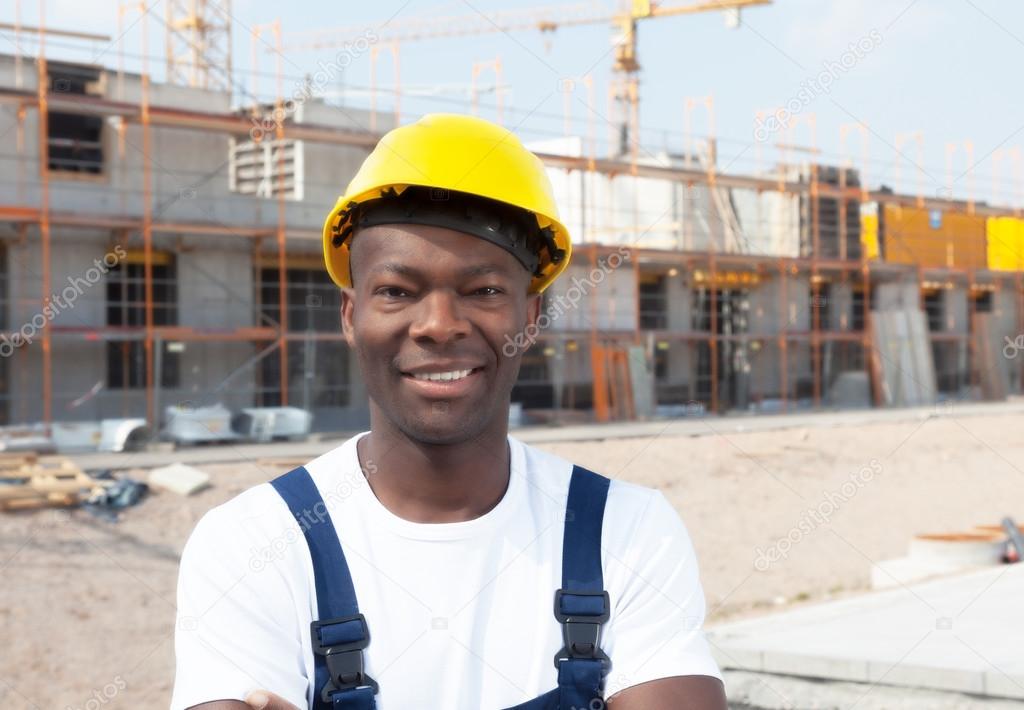 Laughing african american construction worker at building site