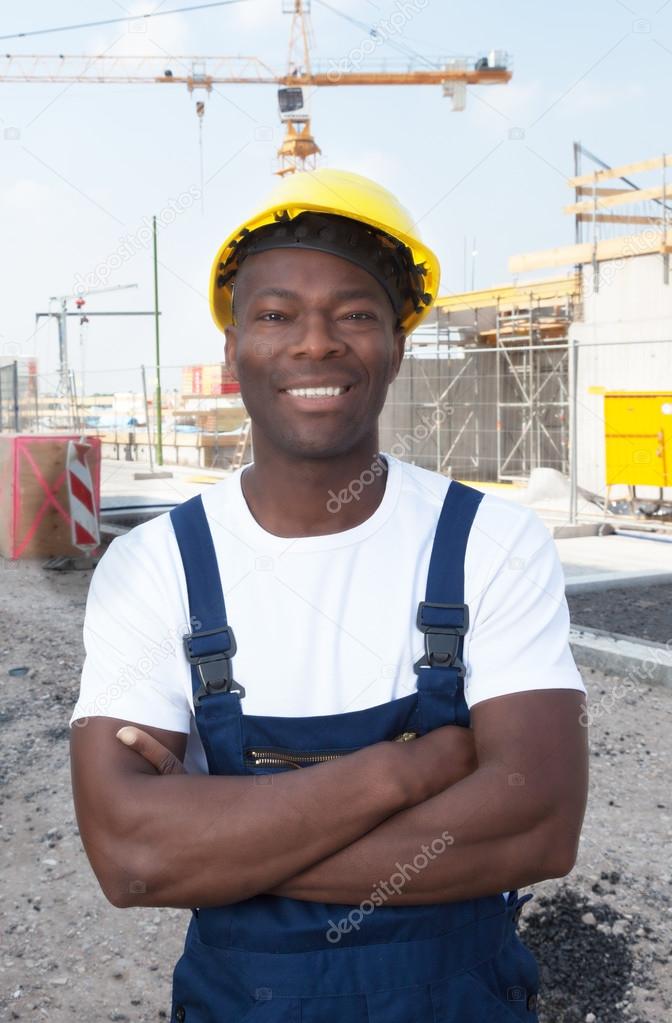 Muscular african american construction worker at building site