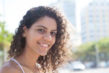Latin woman outside in the city looking at camera clipart