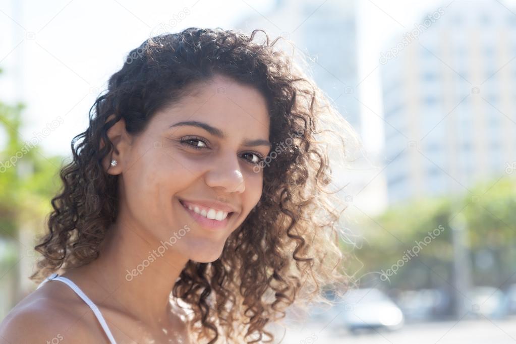 Latin woman outside in the city looking at camera