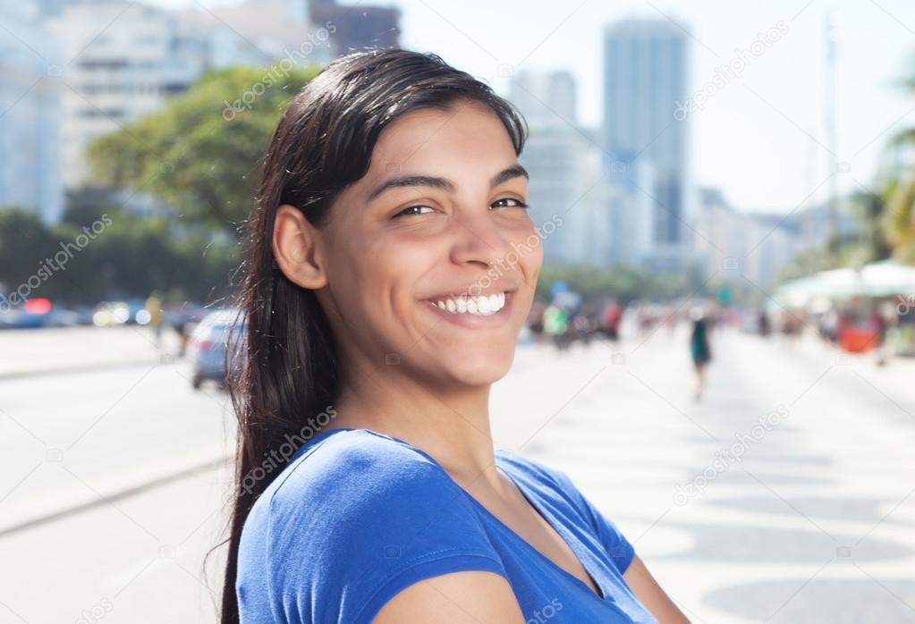 Happy latin woman with long dark hair in the city