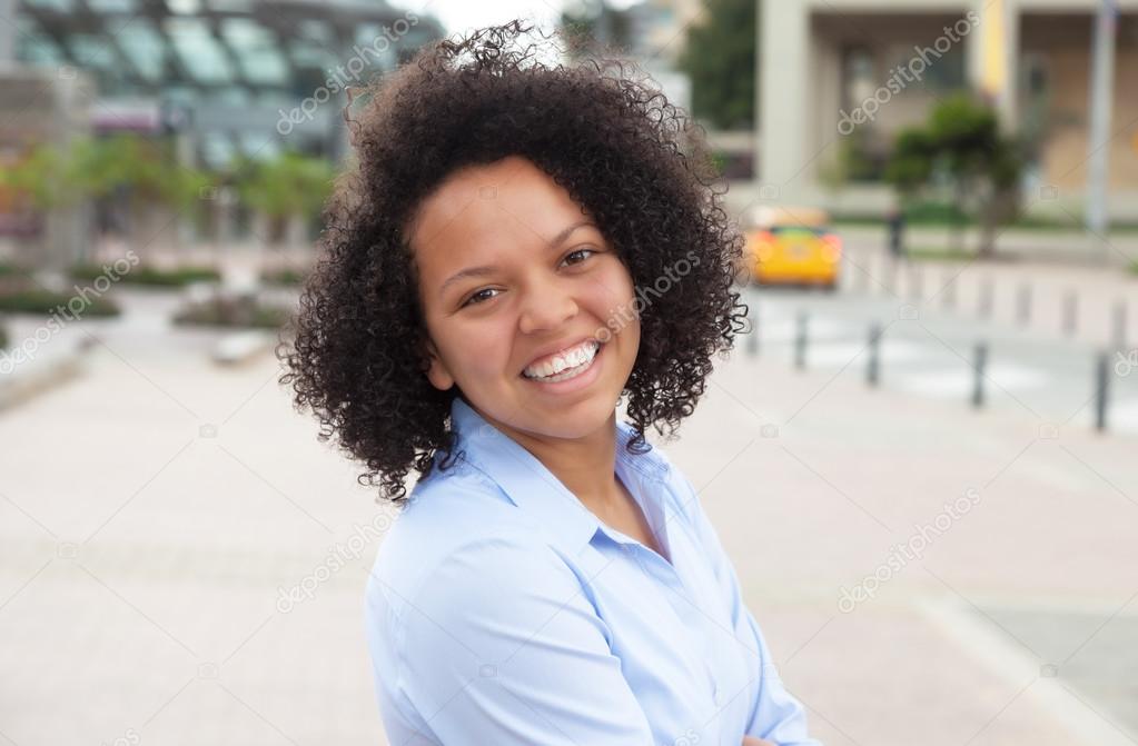 Happy african american woman in the city