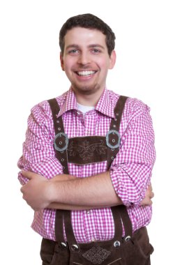 Laughing bavarian guy with leather pants and crossed arms clipart