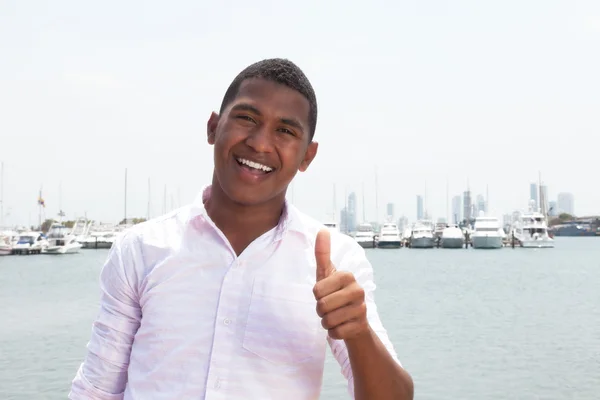Happy caribbean guy showing thumb outside — Stock Photo, Image