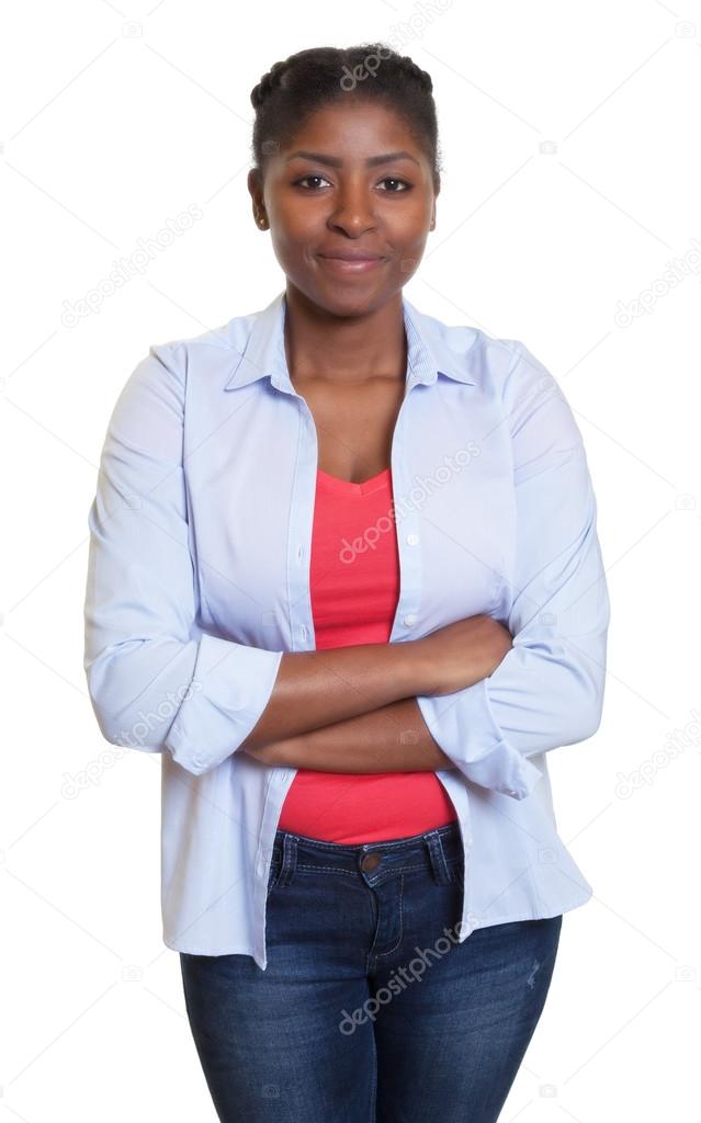 Smiling african woman with jeans and crossed arms