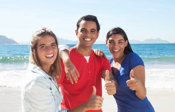 Group of three happy latin people at beach — Stock Photo, Image