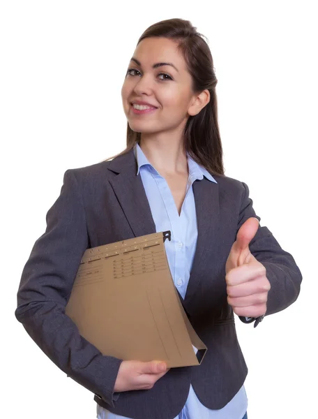 Businesswoman with brown hair and file showing thumb — Stock Photo, Image