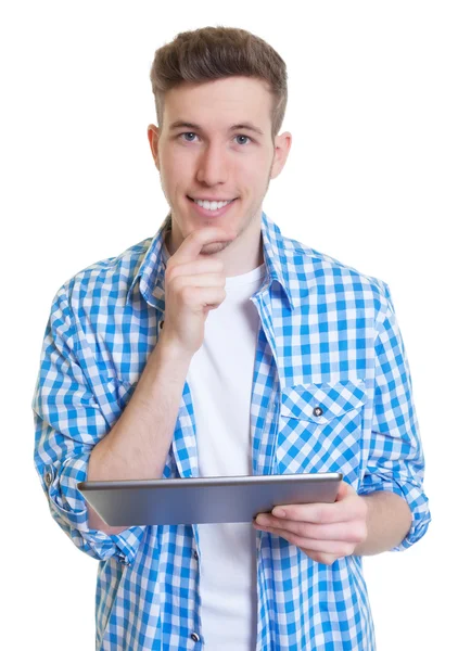 Guy in a checked shirt with tablet looking at camera — Stock Photo, Image