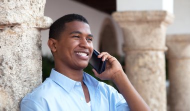 Telefon bir koloni kasabasında Latin adam gülüyor