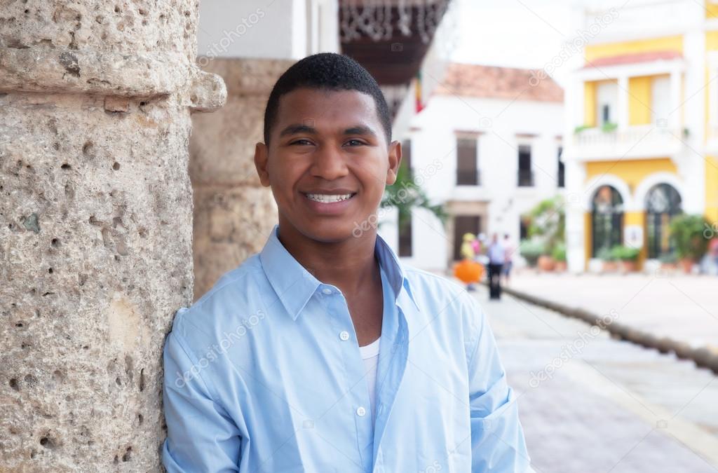 Young guy in a blue shirt in a colonial town