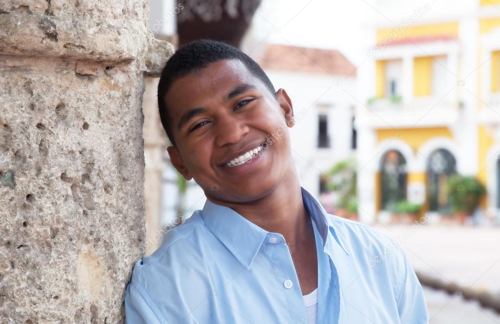 Modern guy in a blue shirt in a colonial town