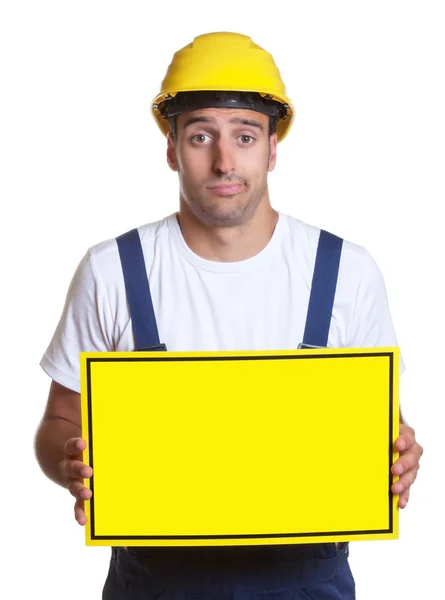 Clueless latin construction worker with sign — Stock Photo, Image