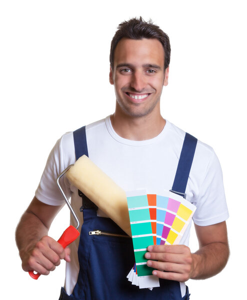 Happy painter with painting roller and colors