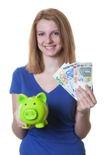 Woman with red hair and piggy bank showing money — Stock Photo, Image