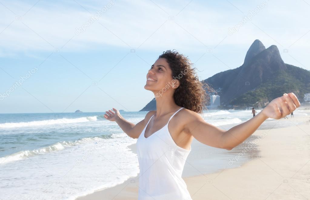 Latin woman at beach enjoying the air