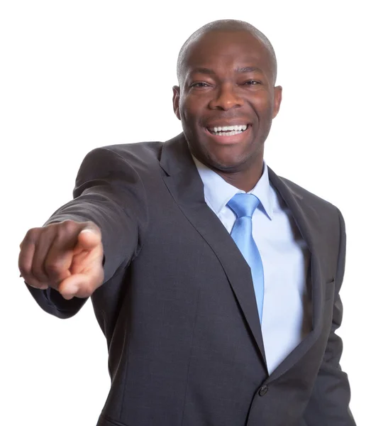 Pointing african businessman in a dark suit Royalty Free Stock Photos