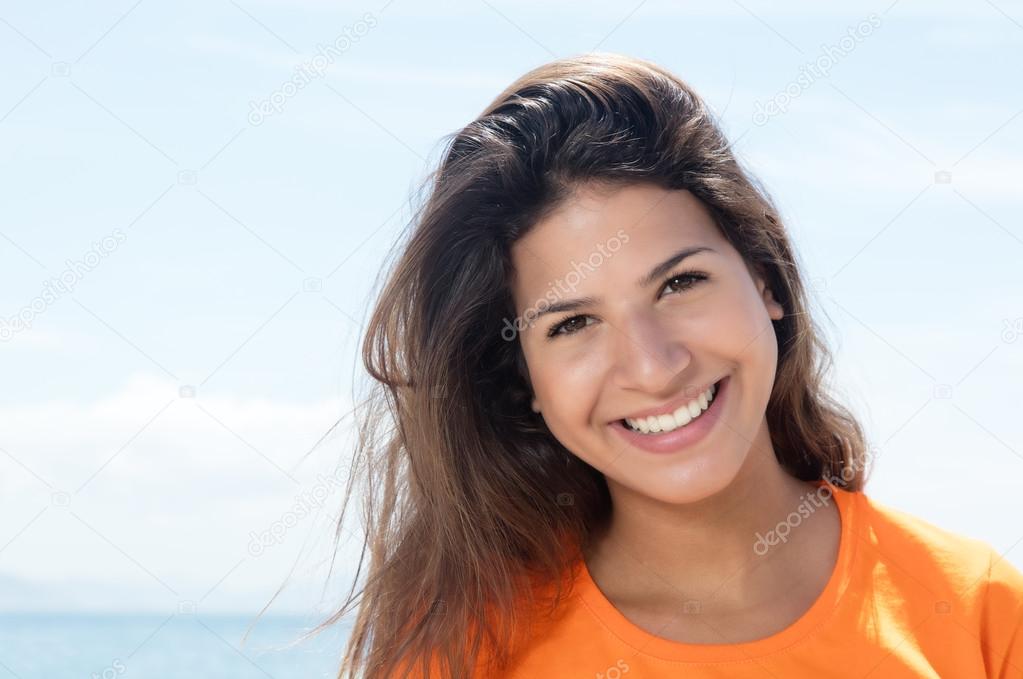 Happy caucasian woman in a orange shirt