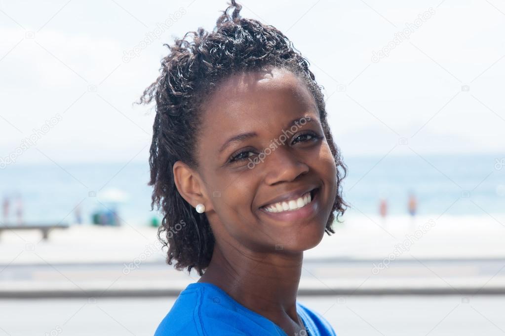 Happy african american woman in a blue shirt