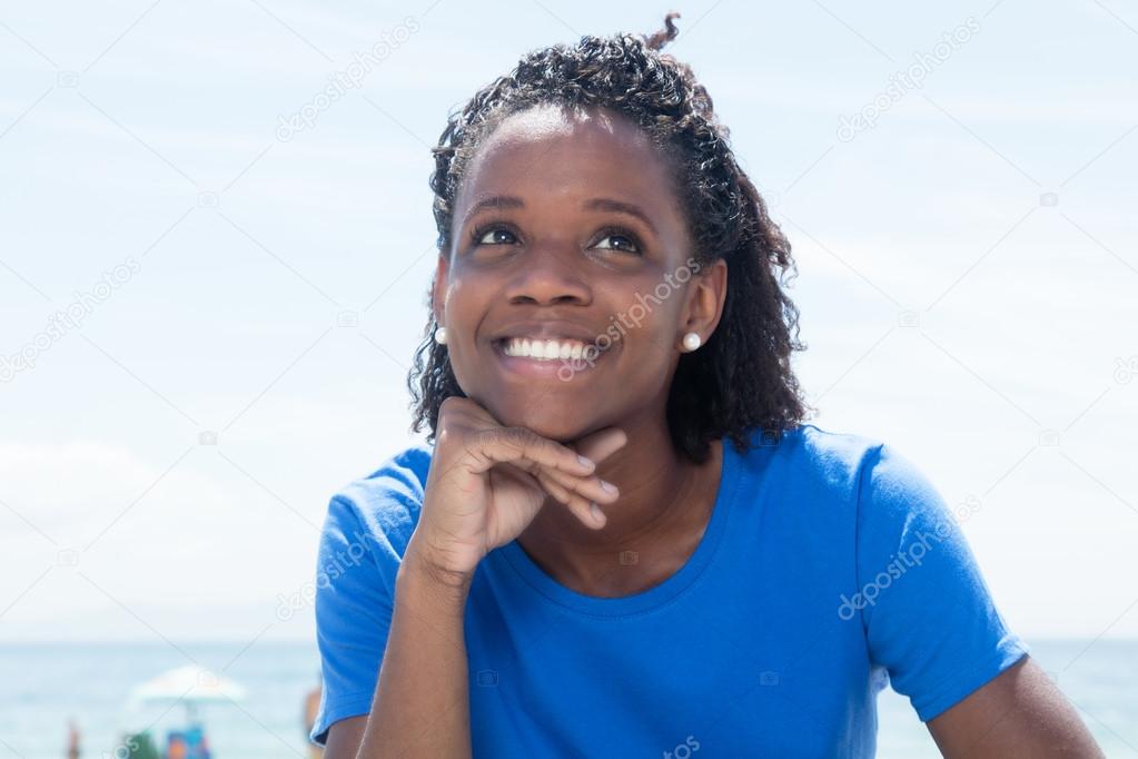 Dreaming african american woman in a blue shirt