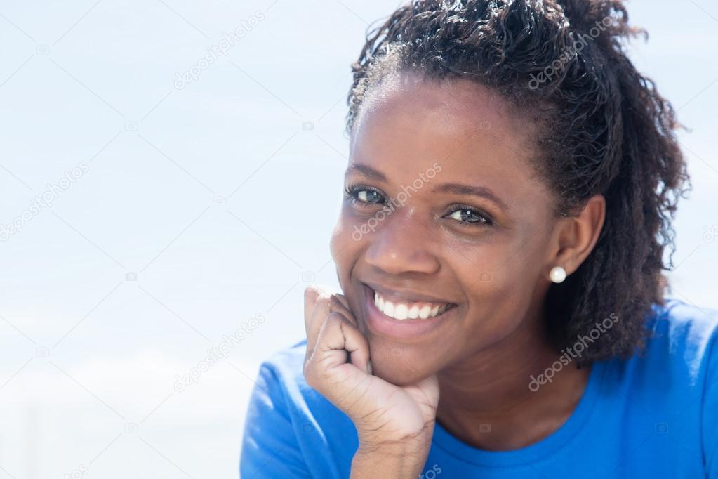 Laughing african american woman in a blue shirt