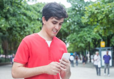 Kırmızı gömlekli tipik haber telefon ile yakışıklı beyaz adam