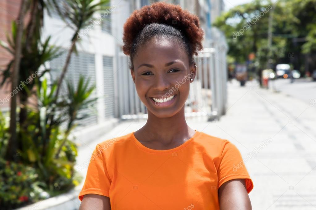 Beautiful african woman in a orange shirt