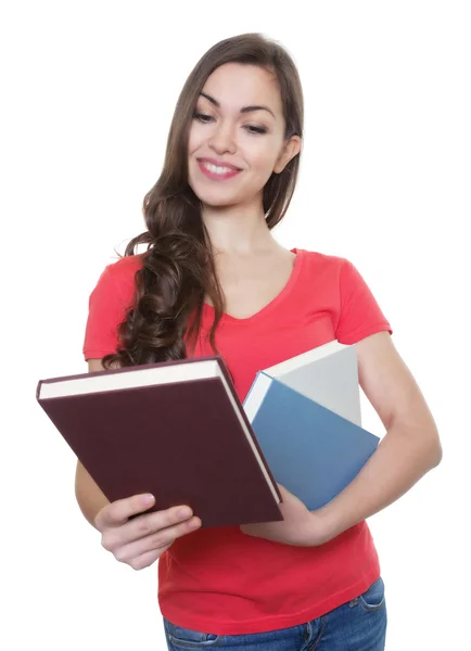 Female student with long dark hair looking at a book — Stock Photo, Image