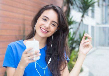 Young caucasian woman loves music clipart