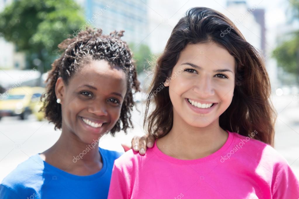 Beautiful african and caucasian women in the city