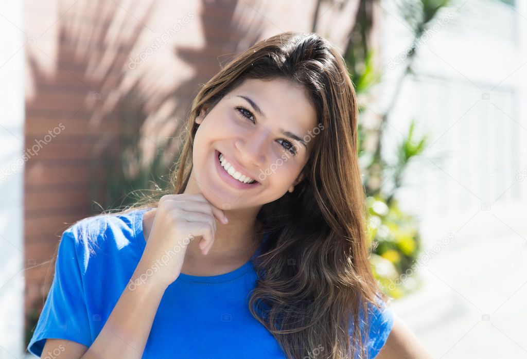 Young caucasian woman in a blue shirt in the city