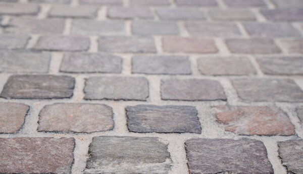 Background image of set of granite Grey brick stone street road. Light sidewalk, pavement