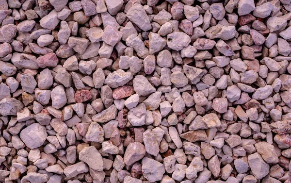 Stone background. blue gravel. Granite texture. The rocky road. Fine pebbles. Construction material. The texture of the stones. Wallpaper with fine gravel.