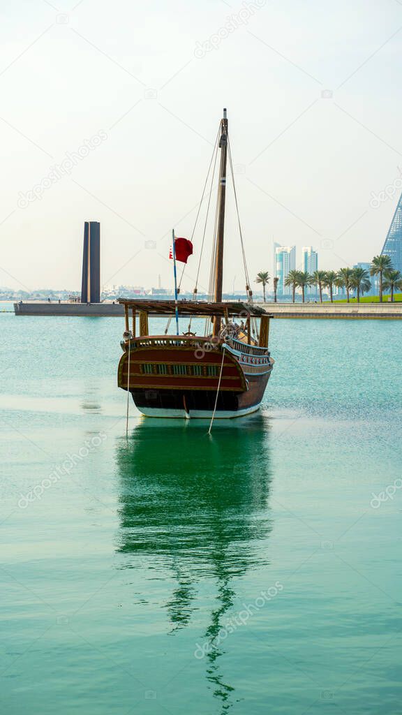 DOHA, QATAR - FEB 14: Traditional boats called Dhows are anchored in the port near Museum of Islamic Art Park on February 14, 2020 in Doha, Qatar.