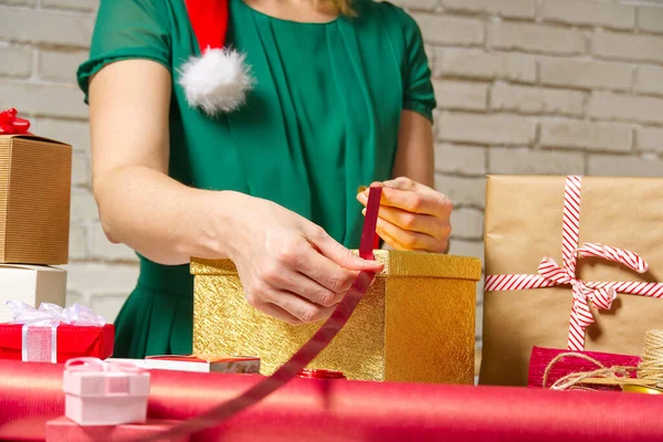 woman wrapping gift for christmas st. valentine, birthday at gift wrapping station