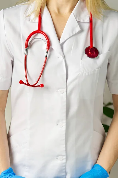 Bright close up of doctor with red stethoscope. Medical background — Stock Photo, Image