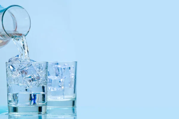 Pouring fresh water. Pouring clean drinking water from a glass decanter to glass.