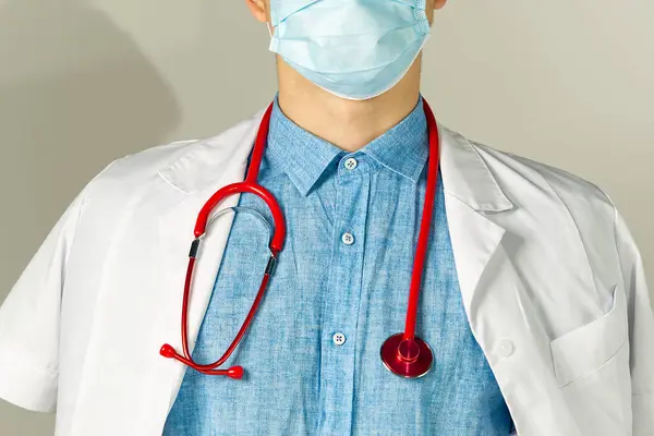 Bright close up of doctor with red stethoscope. Medical background — Stock Photo, Image