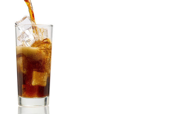 Pouring Cola to glass with ice cubes isolated on white