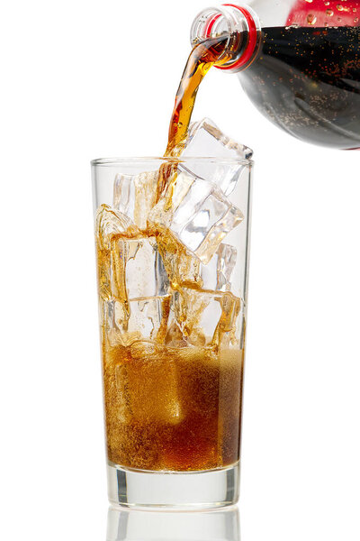 Pouring Cola to glass with ice cubes isolated on white