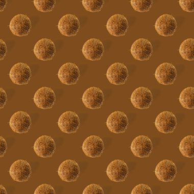 Hindistan cevizi aralıksız desen. Kahverengi arka planda izole edilmiş hindistan cevizi olan tropik soyut bir arka plan. düz yat.