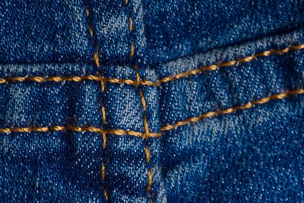 Cucitura su jeans. blu jeans macro texture sfondo. — Foto Stock