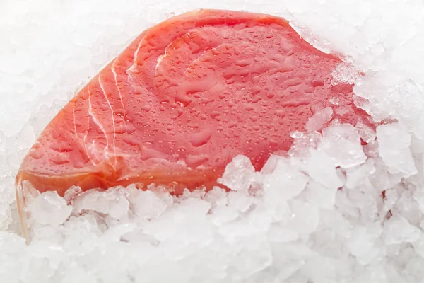 Frozen Tuna steak vacuum with ice on the counter the fishmarket. healfy food and nutrition concept