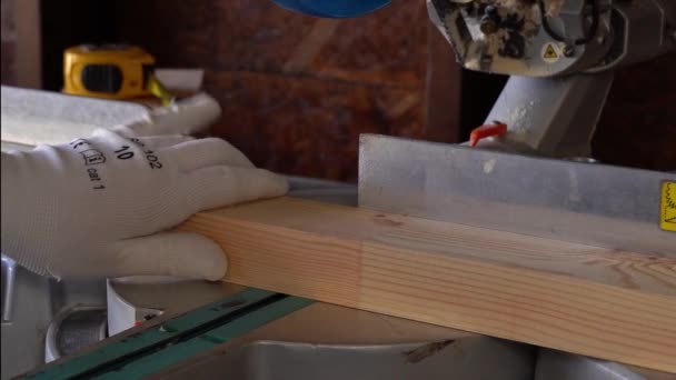 Closeup of professional cabinet makers working with electric circular saw at woodworking workshop. — Stock Video