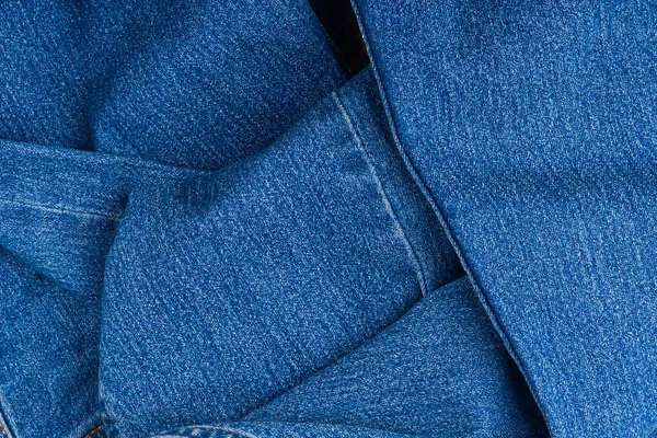 Splinternieuwe blauwe jeans textiel. jeans macro textuur achtergrond. — Stockfoto