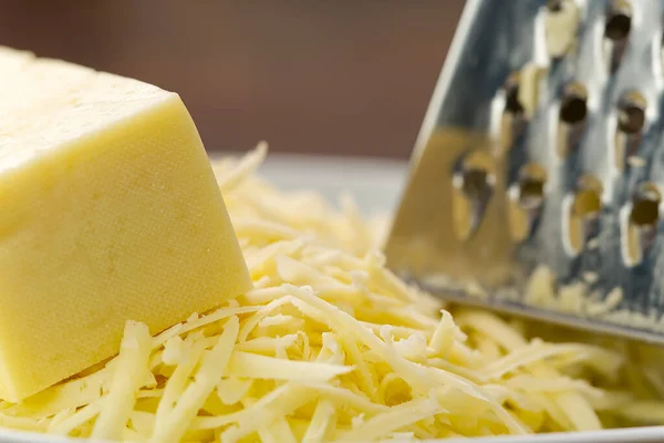 Сыр с тертым сыром, крупным планом. размытый фон — стоковое фото