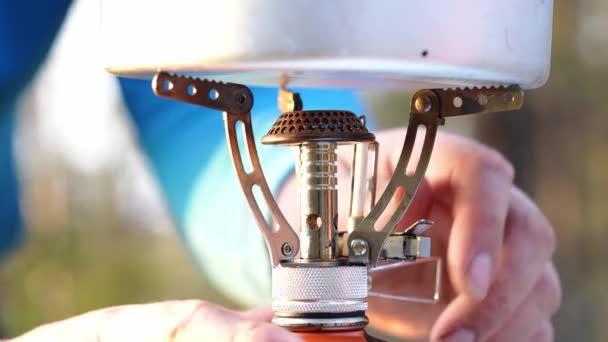 Firing camping gas stove. Man Burning Camping Stove to Boiling Water — Wideo stockowe