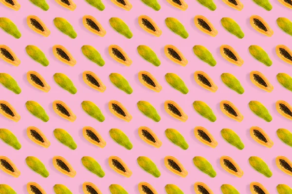 Fresh ripe papaya background on pink backdrop. Tropical abstract background. Top view. modern — Stock Photo, Image