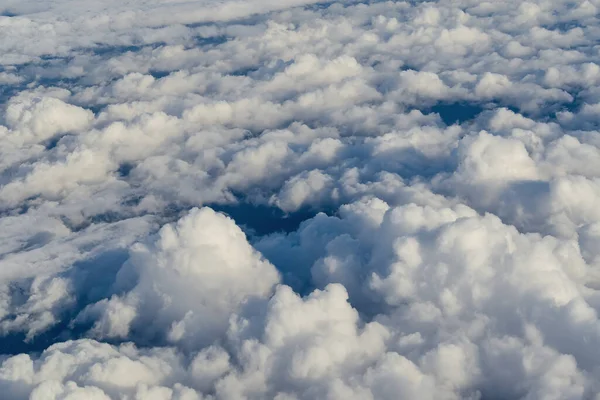 View of the sky above the clouds. blue sky high view from airplane window clouds shapes. sky-clouds background